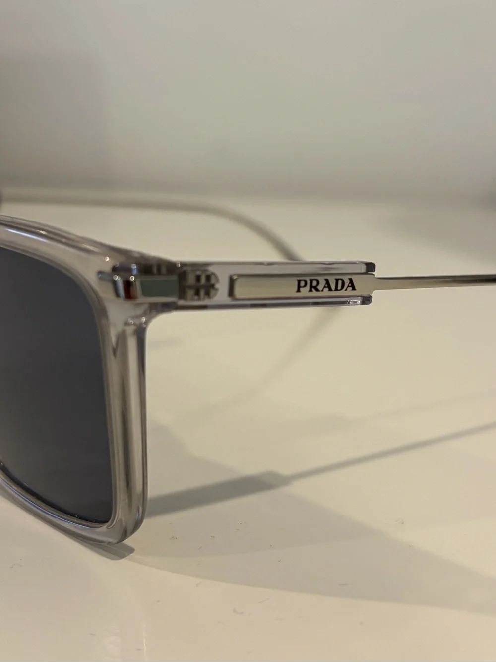 Prada Men’s Clear Frame Sunglasses with Dark Blue Lenses